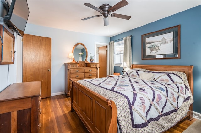 bedroom with ceiling fan, baseboards, and wood finished floors