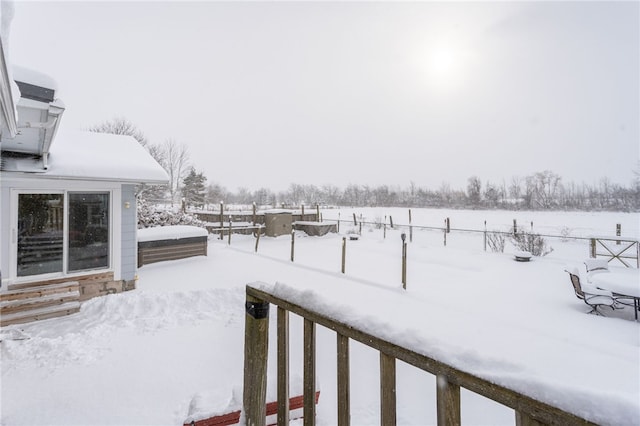 snowy yard featuring fence