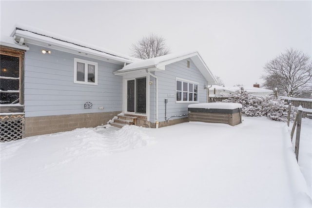 snow covered property with an outbuilding