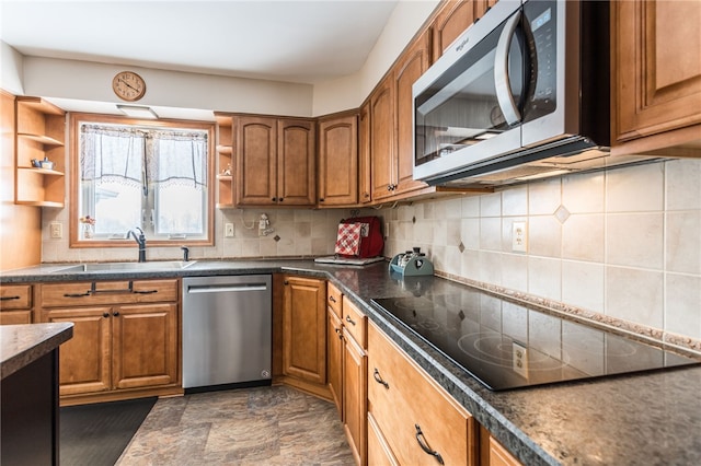 kitchen with stainless steel appliances, open shelves, a sink, and brown cabinets