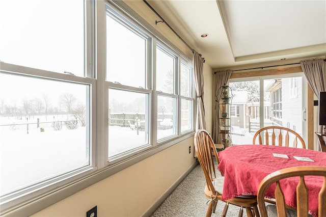 dining space with carpet flooring and baseboards