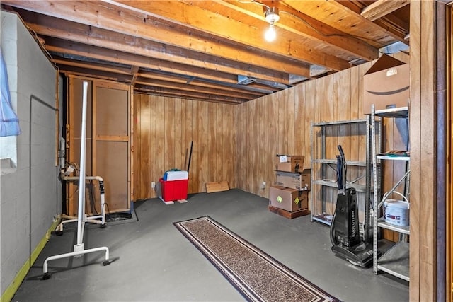 exercise room with concrete block wall and wood walls