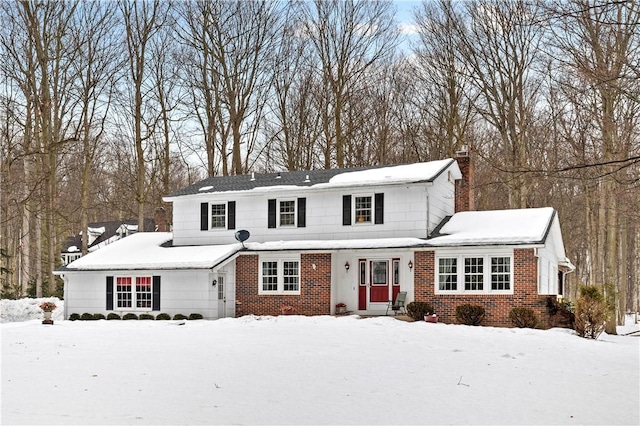 traditional-style house with brick siding and a chimney