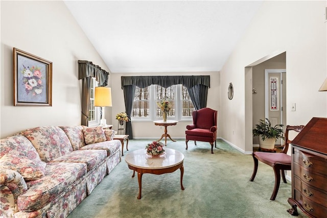 carpeted living area featuring high vaulted ceiling and baseboards