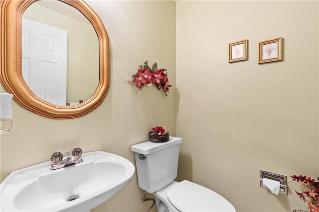 half bath featuring a sink and toilet