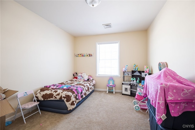 bedroom with carpet floors, baseboards, and visible vents