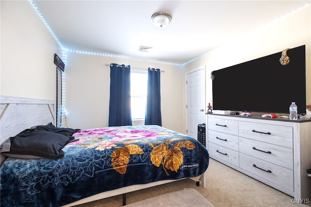 bedroom featuring light carpet and visible vents