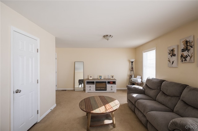 living room featuring light carpet and baseboards