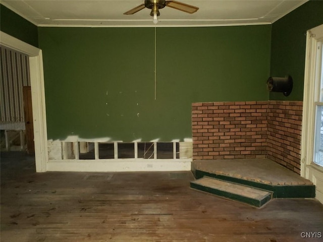 interior space featuring ornamental molding, ceiling fan, and wood finished floors