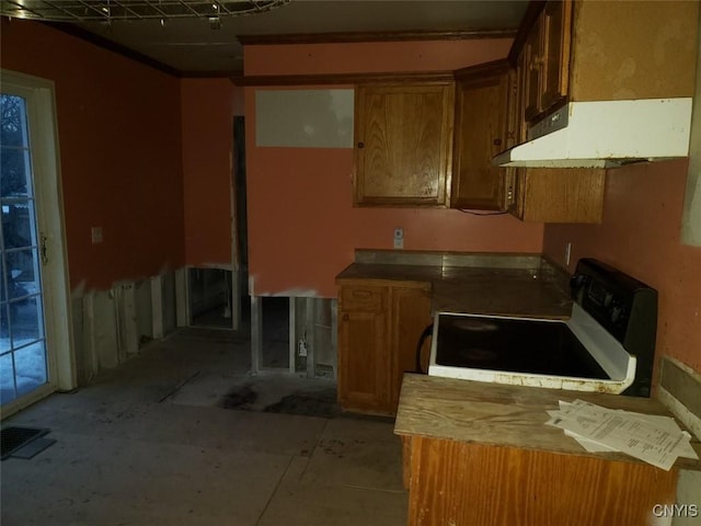 kitchen with electric stove, brown cabinets, light countertops, visible vents, and under cabinet range hood