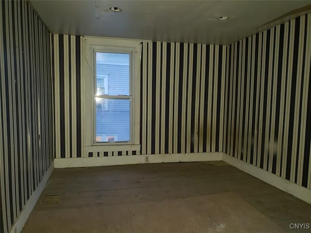 unfurnished room with visible vents