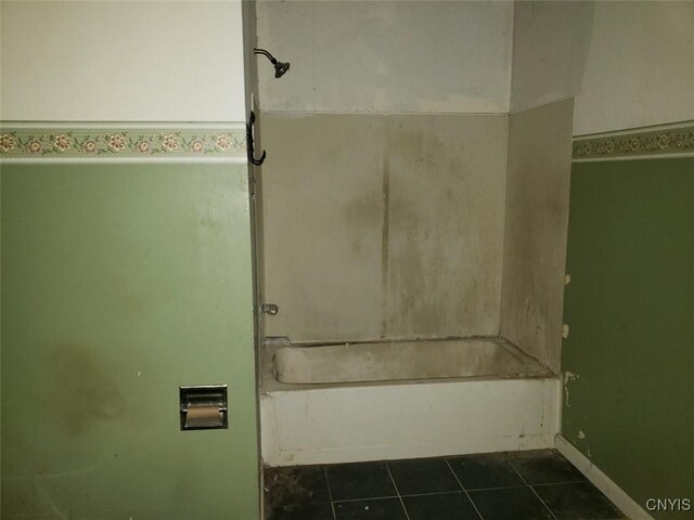 bathroom featuring shower / bathtub combination and tile patterned flooring