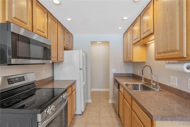 kitchen with appliances with stainless steel finishes, recessed lighting, a sink, and light tile patterned floors