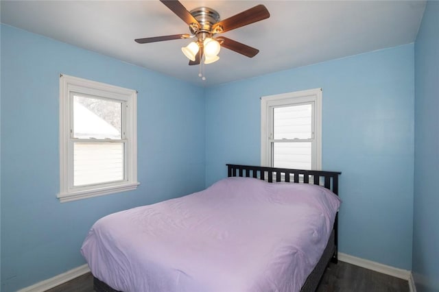 bedroom featuring ceiling fan, dark wood-type flooring, and baseboards