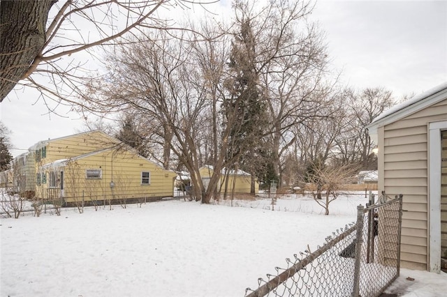 yard covered in snow with fence