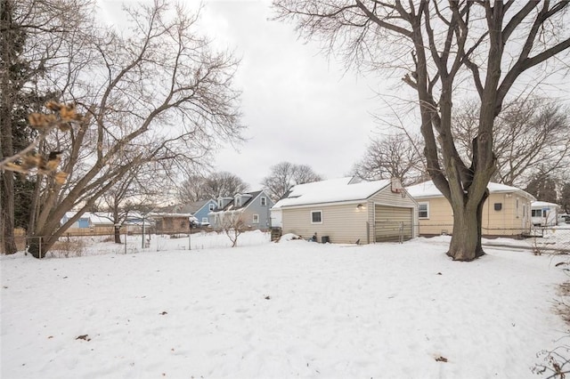 exterior space with a garage, an outdoor structure, and fence