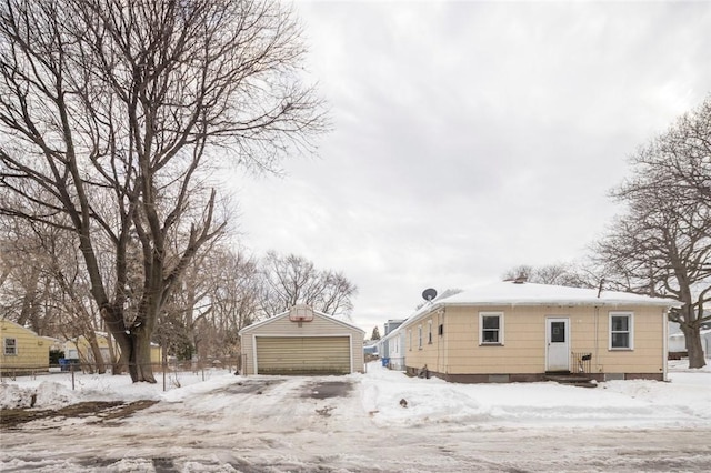 exterior space with a garage, an outbuilding, and fence