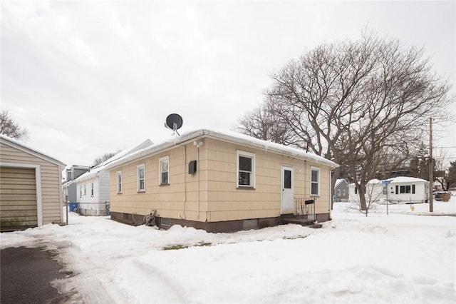 view of snow covered rear of property