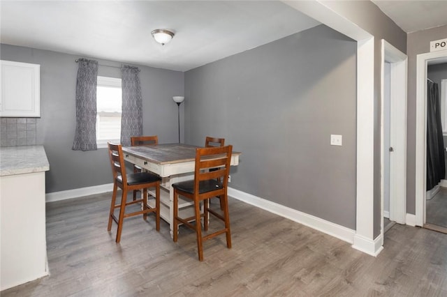 dining space with wood finished floors and baseboards