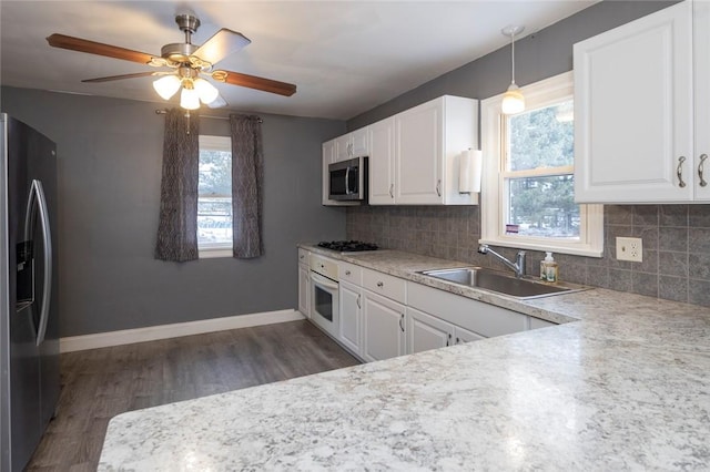 kitchen with plenty of natural light, tasteful backsplash, stainless steel appliances, and a sink