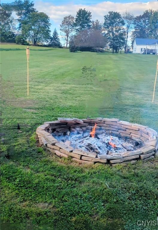 view of yard with an outdoor fire pit