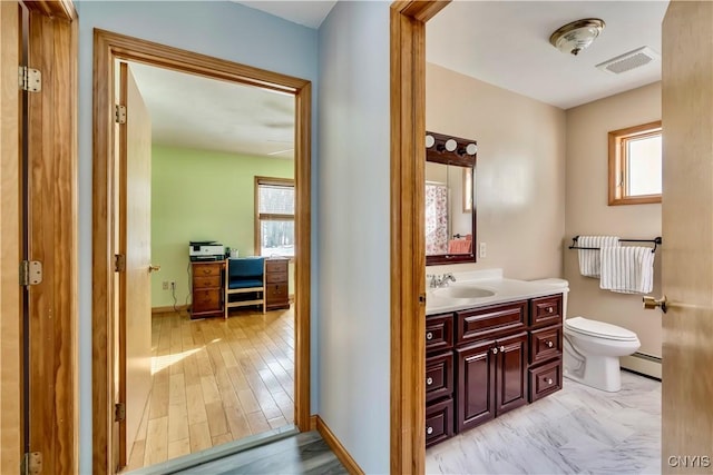 bathroom featuring a healthy amount of sunlight, a baseboard radiator, visible vents, and toilet