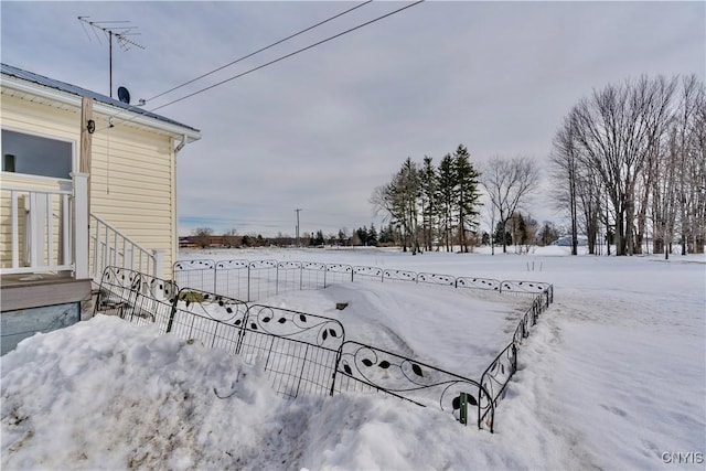 view of yard layered in snow