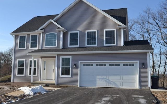 view of front of house with a garage and aphalt driveway