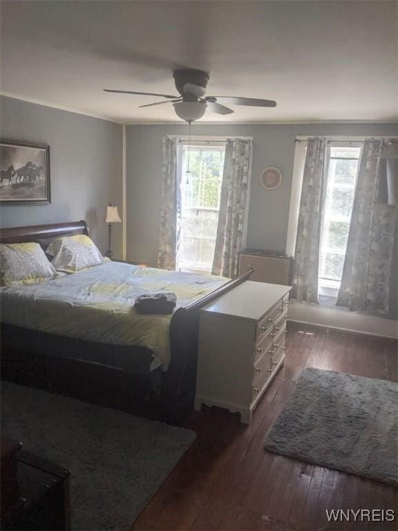 bedroom with dark wood-style floors and ceiling fan