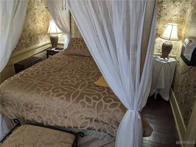 bedroom featuring wallpapered walls and hardwood / wood-style flooring