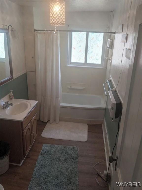 bathroom featuring shower / bath combo, wood finished floors, and vanity