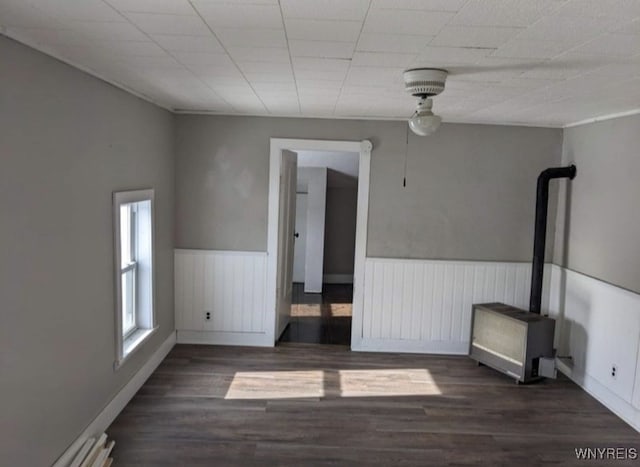 empty room featuring a wainscoted wall and wood finished floors