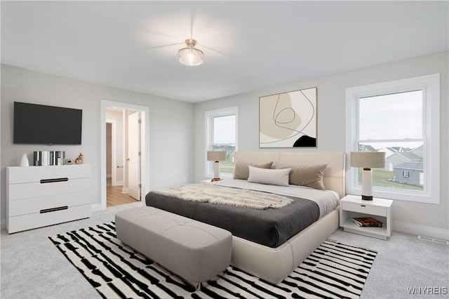 carpeted bedroom with visible vents and baseboards