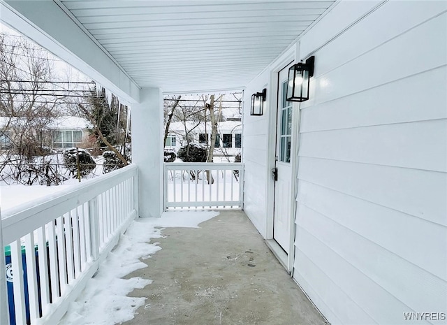 view of snow covered back of property