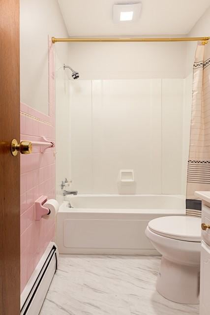 full bath with toilet, a baseboard radiator, shower / bath combination with curtain, and tile walls