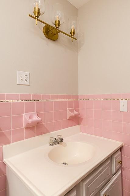 bathroom featuring a wainscoted wall, tile walls, and vanity