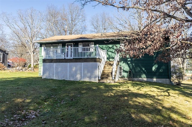 back of house with stairs and a yard