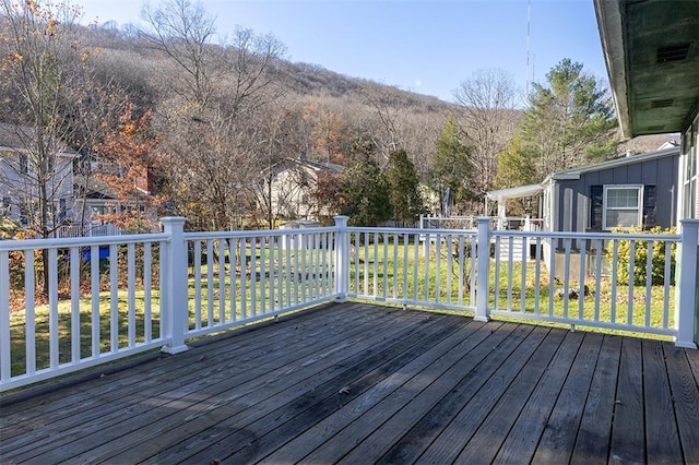 wooden terrace featuring a lawn