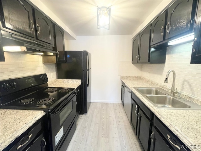 kitchen with light wood-style floors, black / electric stove, light countertops, and a sink