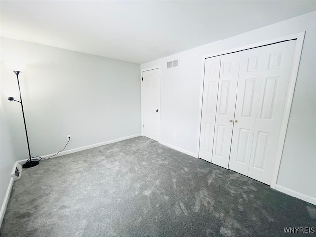 unfurnished bedroom featuring carpet, visible vents, and baseboards