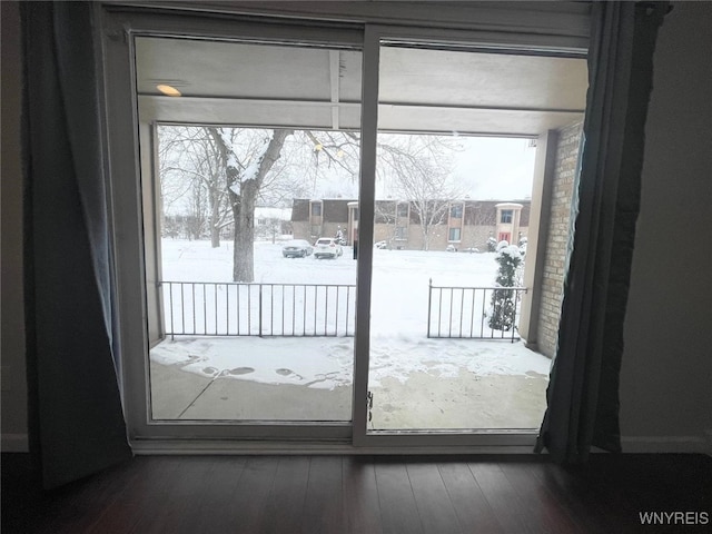 entryway featuring dark wood-type flooring and a residential view