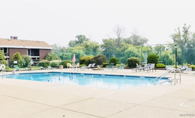 pool featuring a patio and fence