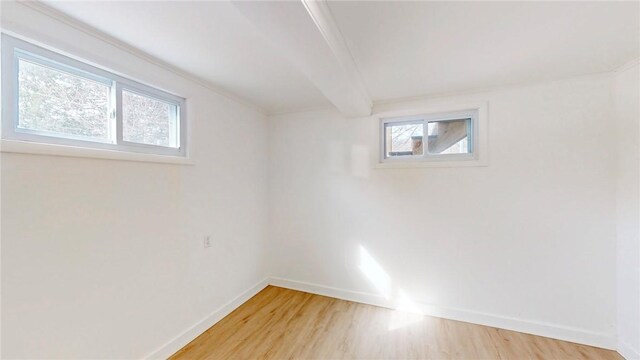 empty room featuring light wood-style flooring and baseboards