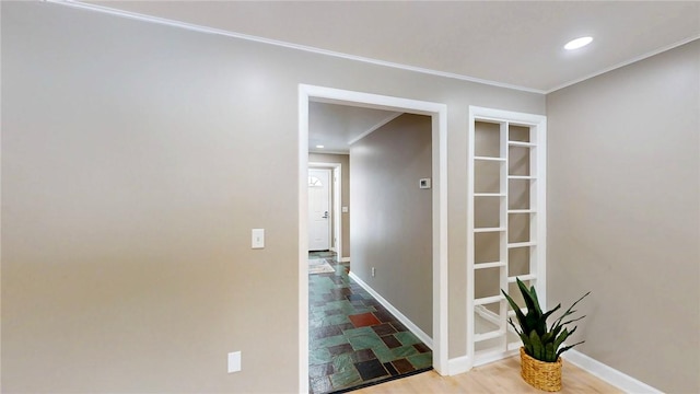 corridor with baseboards, recessed lighting, and crown molding