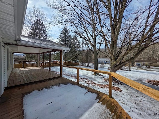 snowy yard with a wooden deck