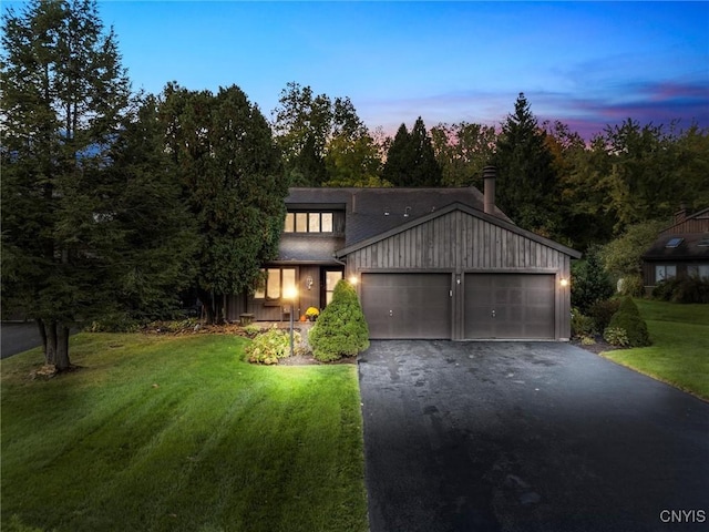 view of front of home with driveway, a garage, and a front lawn