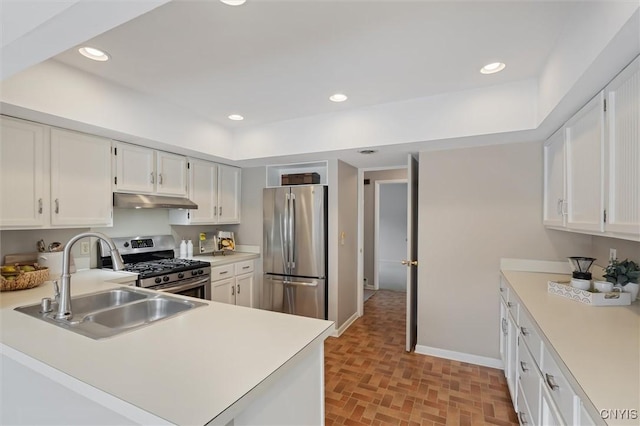 kitchen with stainless steel appliances, recessed lighting, light countertops, a sink, and under cabinet range hood