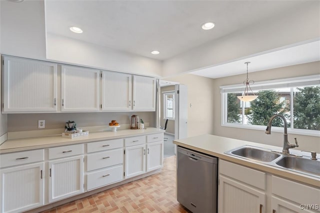 kitchen with recessed lighting, white cabinetry, dishwasher, and a sink