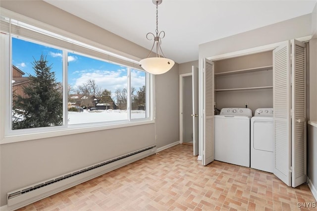 laundry area with brick floor, laundry area, a baseboard radiator, and washer and dryer