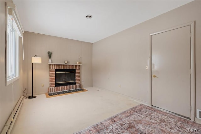 living room with a brick fireplace, visible vents, and a baseboard heating unit